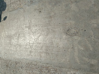 Cracks developed on repaired surface of scaled pavement slab