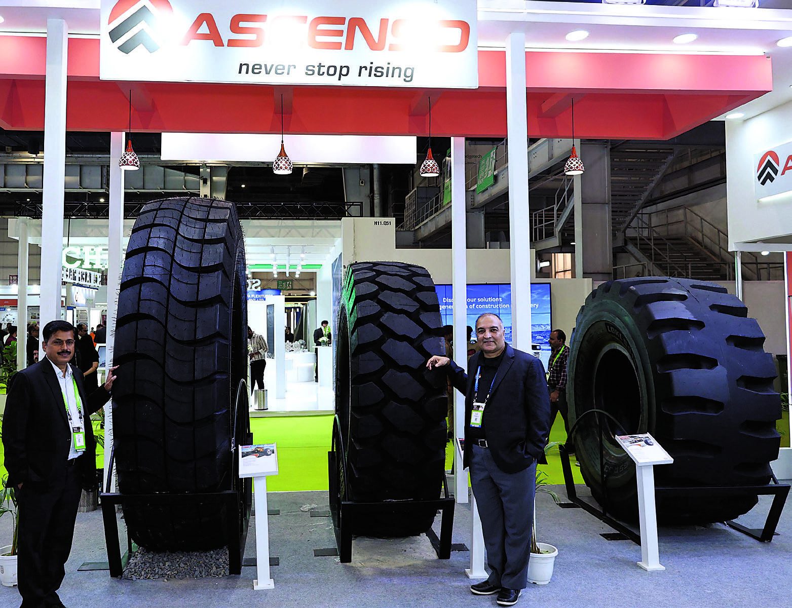 Ascenso representatives with giant mining tyres at the exhibition