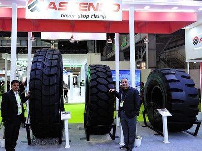 Ascenso representatives with giant mining tyres at the exhibition